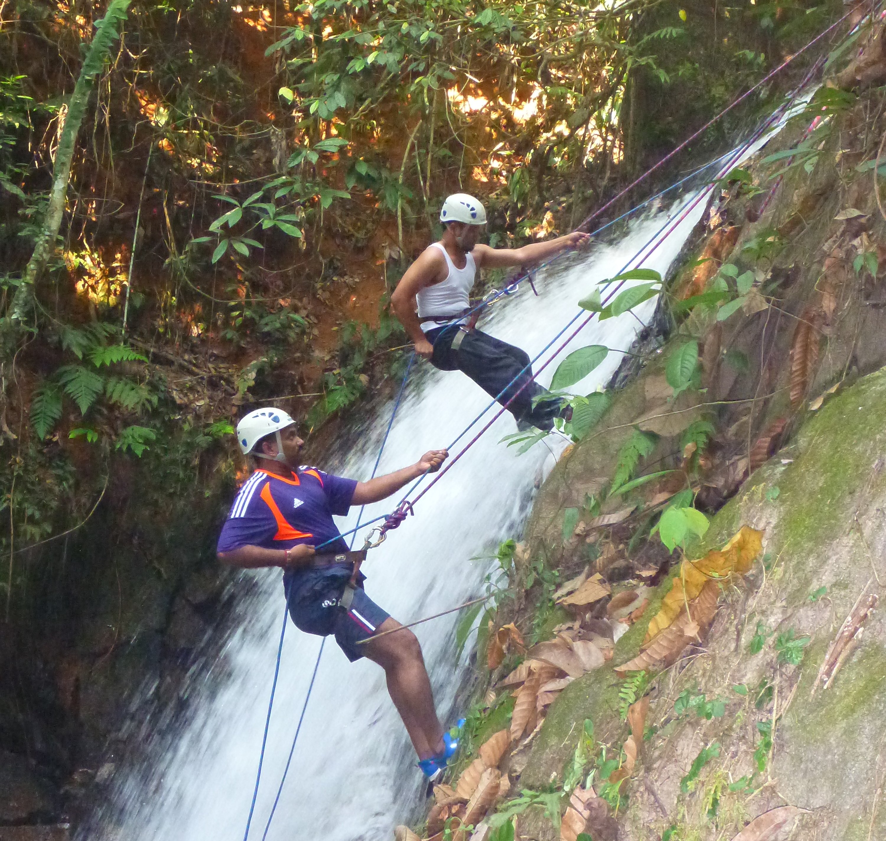 Student abseiling down waterfall